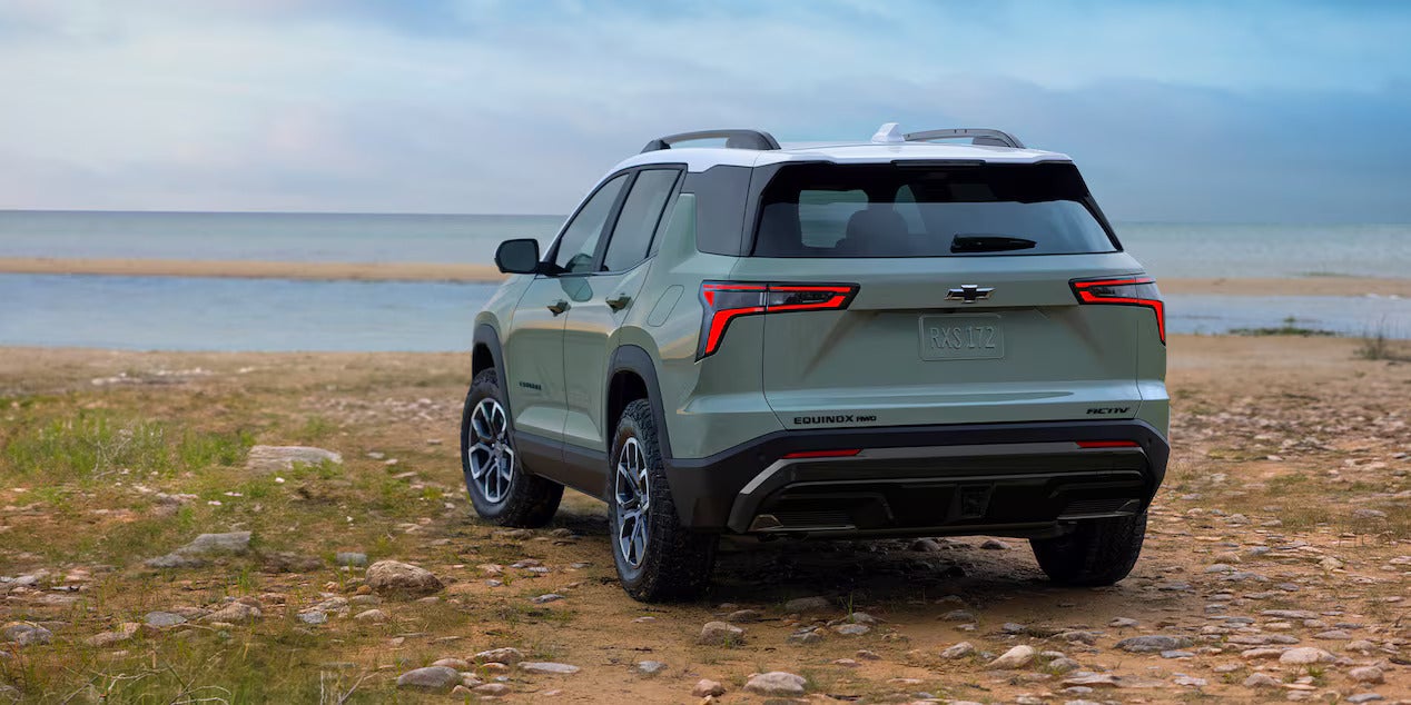 the behind of an suv next to body of water