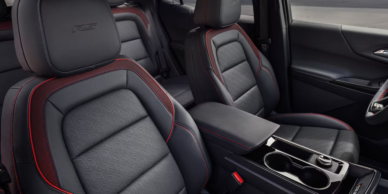 dark gray front seats with red accents in an suv