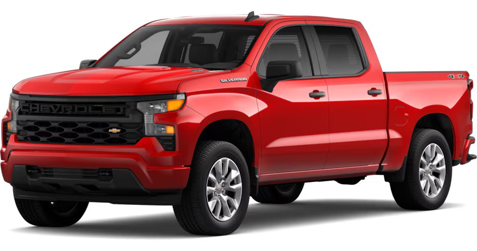 Red 2025 Chevrolet Silverado Custom model with a bold front grille and rugged design, showcasing versatility and style.