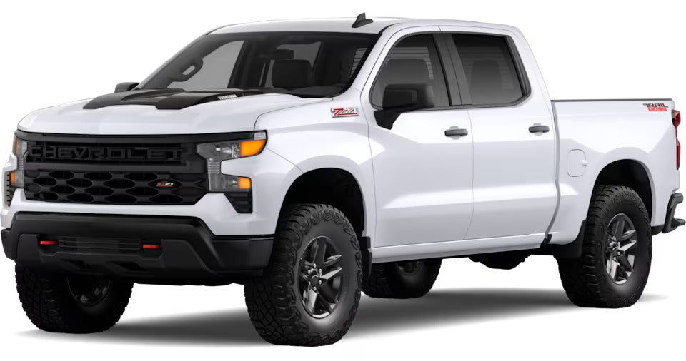 White 2025 Chevrolet Silverado Custom Trail Boss with off-road tires, showcasing rugged design elements.